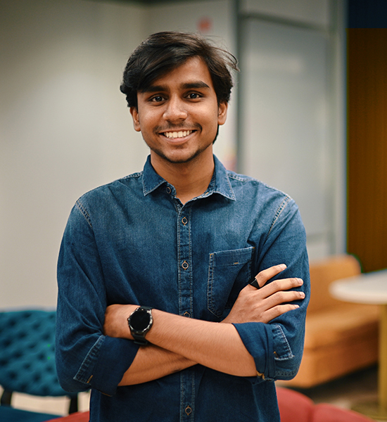 A portrait of a man standing in an office